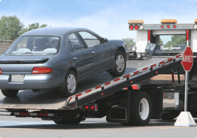 Car being loaded onto a tow truck.