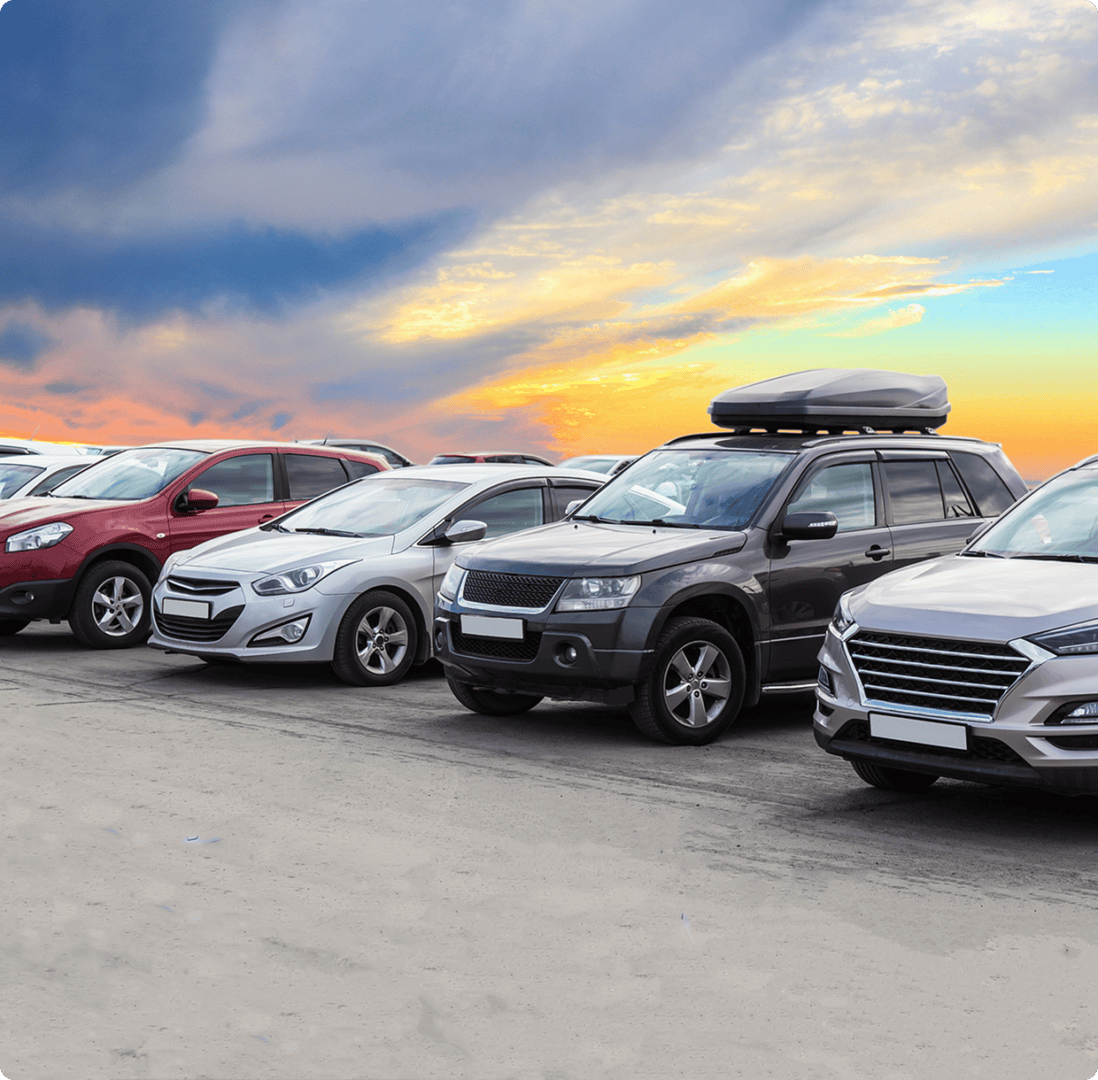 Cars parked under a vibrant sunset sky.