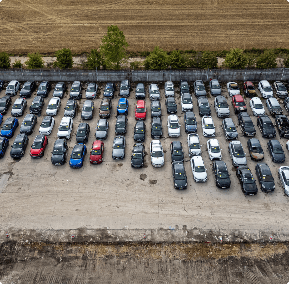 Aerial view of cars parked in rows.